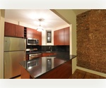 Very unique large 2bed/2bath duplex with private glass enclosed solarium & private garden